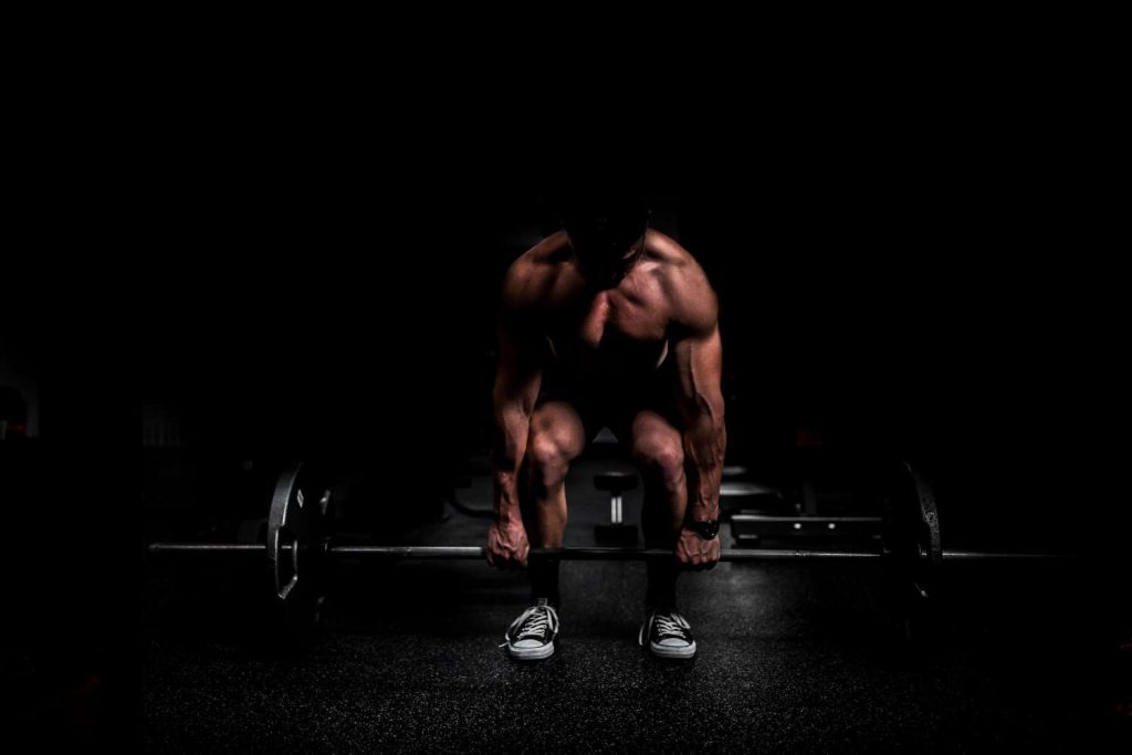 VGL Fitness Anabolic Steroids UK man dead lifting a barbell with weights,